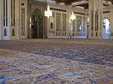 Muscat 04 Grand Mosque 06 Large Persian Carpet The main prayer hall has the largest carpet in the world, a 70m x 60m Persian carpet that took 600 women four years to weave. On the back wall is the mihrab, a niche in the wall facing Mecca. To the right of the mihrab is the minbar, a pulpit chair dating from the Prophet Mohammed�s time. The `imam', the one who leads the prayer, delivers the `khutba', the Friday sermon, which can deal with religious, social and political subjects.
